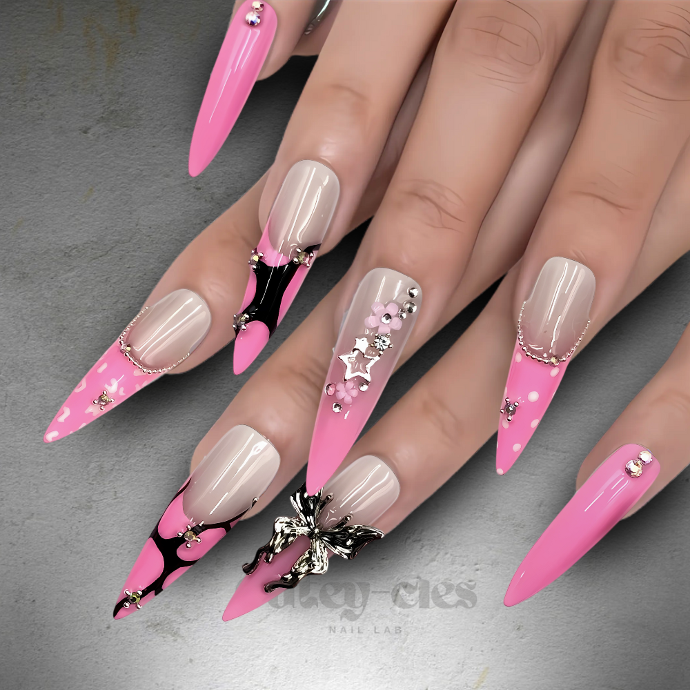 Pink stiletto press-on nails featuring 3D butterfly and floral embellishments with metallic accents, perfect for fairycore or glam nail art enthusiasts.