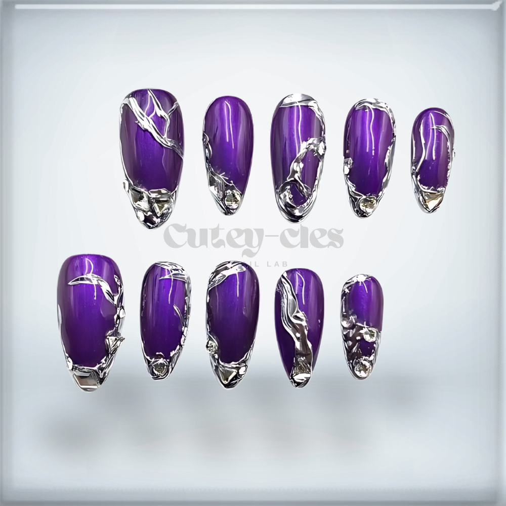 Medium almond nails featuring deep amethyst purple polish with silver metallic 3D chrome accents