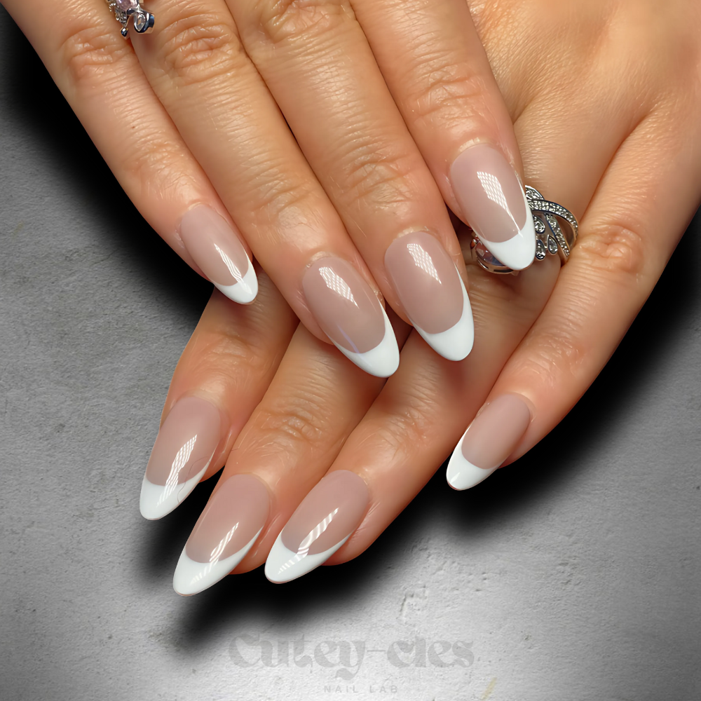 Elegant almond-shaped French tip nails with clean white tips, ideal for a classic and versatile look