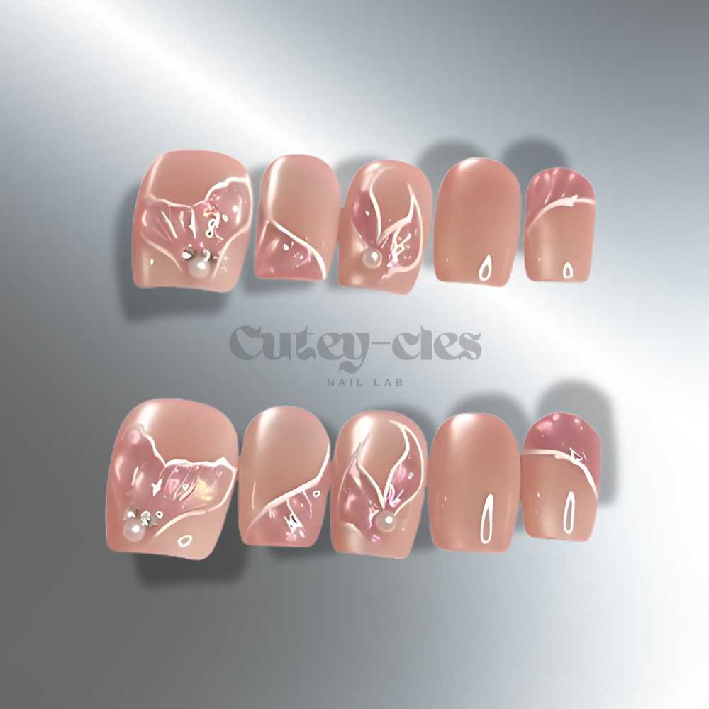 Elegant nude press-on nails with subtle 3D floral accents and soft pink highlights for a timeless look.