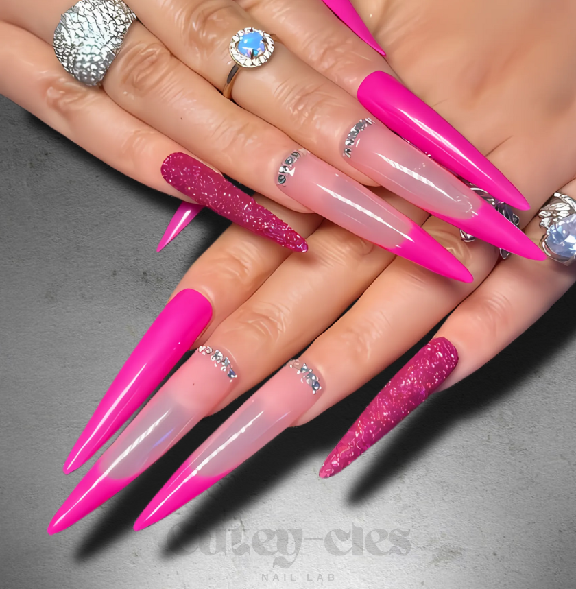 Hot pink stiletto press-on nails with a glossy finish and glitter accent details.