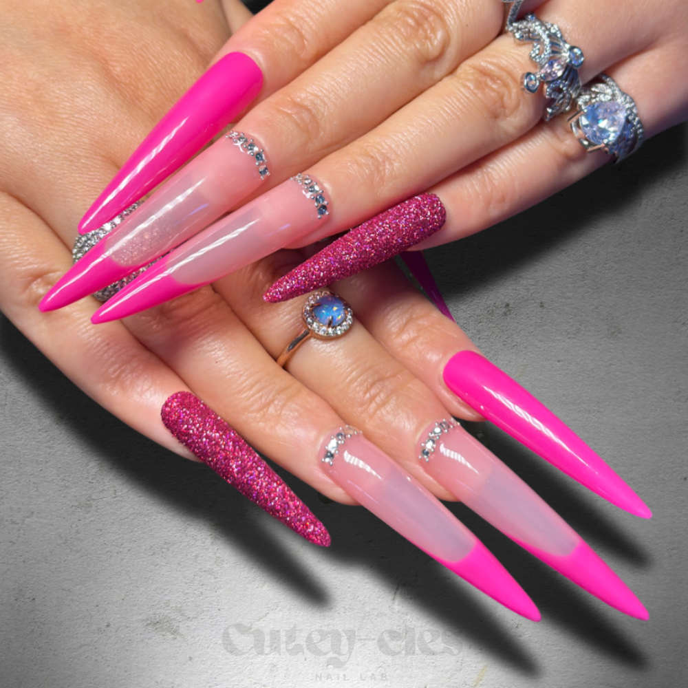 Hot pink stiletto press-on nails with a glossy finish and glitter accent details.