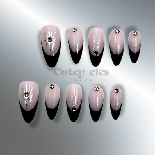 Black French tip nails with lavender-to-black gradient, silver detailing, and rhinestone accents on a black background