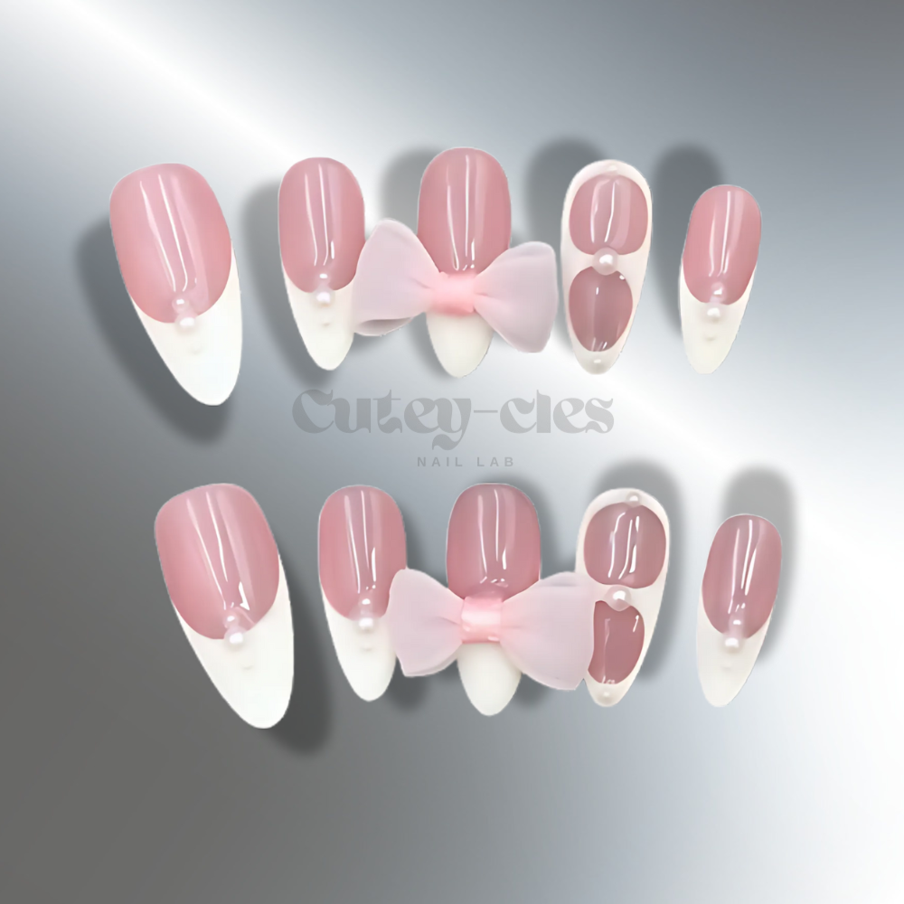 French tip press-on nails with pink bows and pearl accents, ideal for a feminine and elegant look.