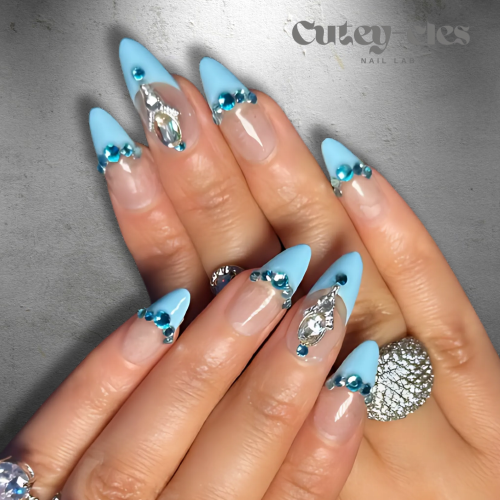 Almond-shaped press-on nails with blue tips, aquamarine and crystal embellishments