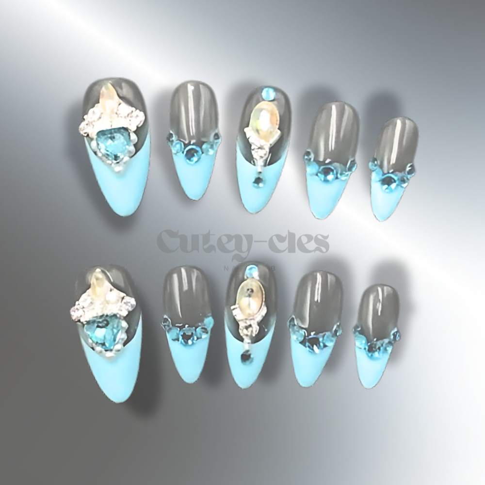 Almond-shaped press-on nails with blue tips, aquamarine and crystal embellishments