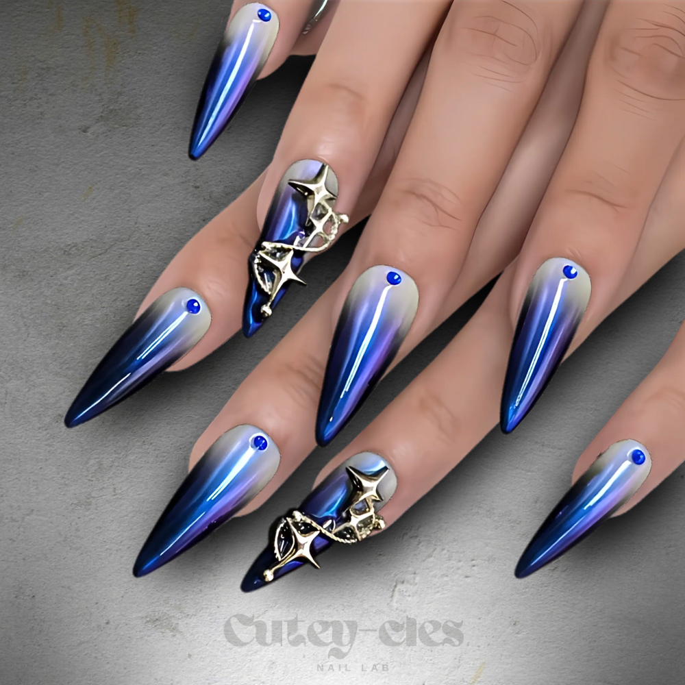 Celestial blue ombré stiletto press-on nails with rhinestone accents and star charm.