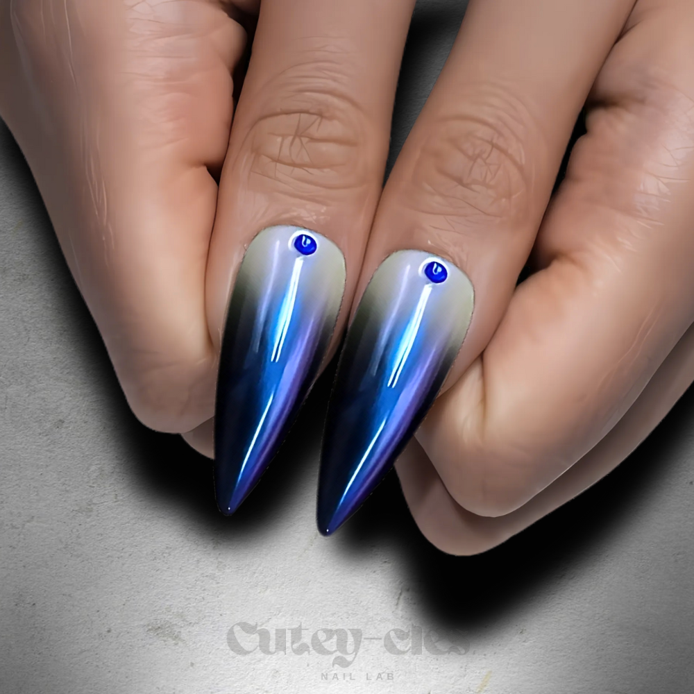 Celestial blue ombré stiletto press-on nails with rhinestone accents and star charm.