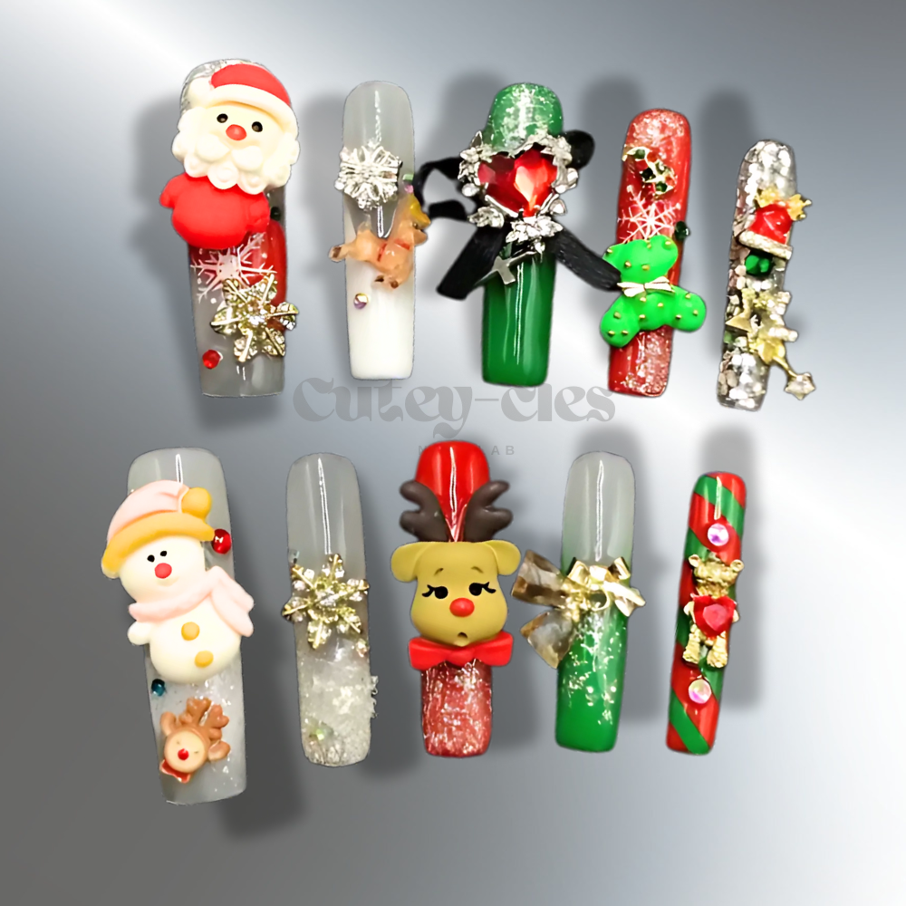 Christmas-themed press-on nails featuring 3D designs of Santa Claus, a reindeer, a snowman, and festive holiday accents in red, green, and gold.