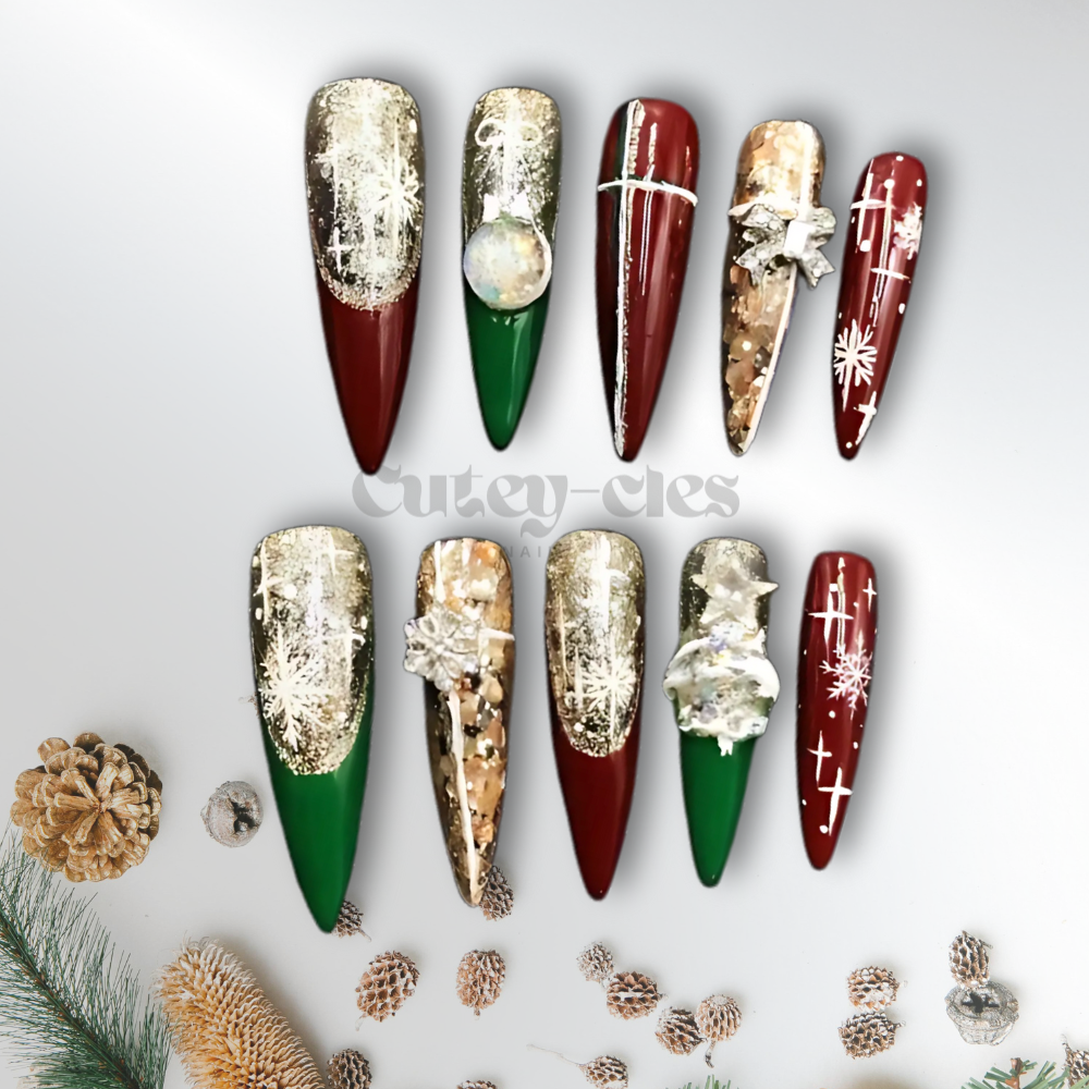 Elegant Christmas press-on nails with long stiletto shapes, featuring burgundy, gold, green, and white accents, decorated with snowflakes, bows, and foil details for a festive holiday look.