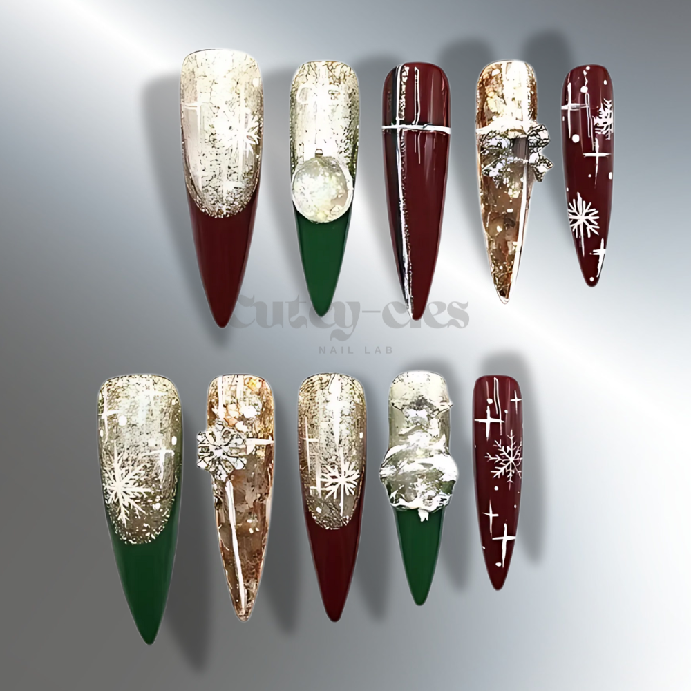 Elegant Christmas press-on nails with long stiletto shapes, featuring burgundy, gold, green, and white accents, decorated with snowflakes, bows, and foil details for a festive holiday look.