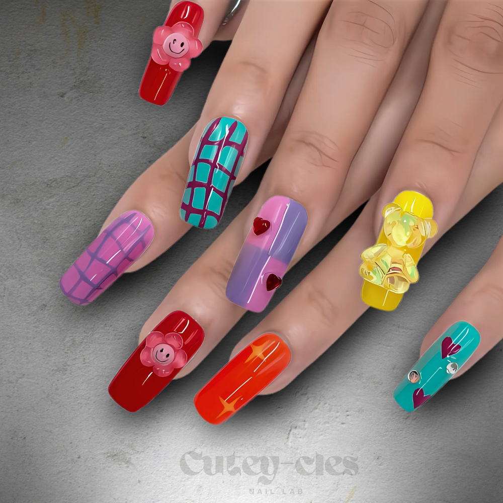 Medium square press-on nail set with bold designs, including kawaii-style charms, pop-art and colorful patterns.