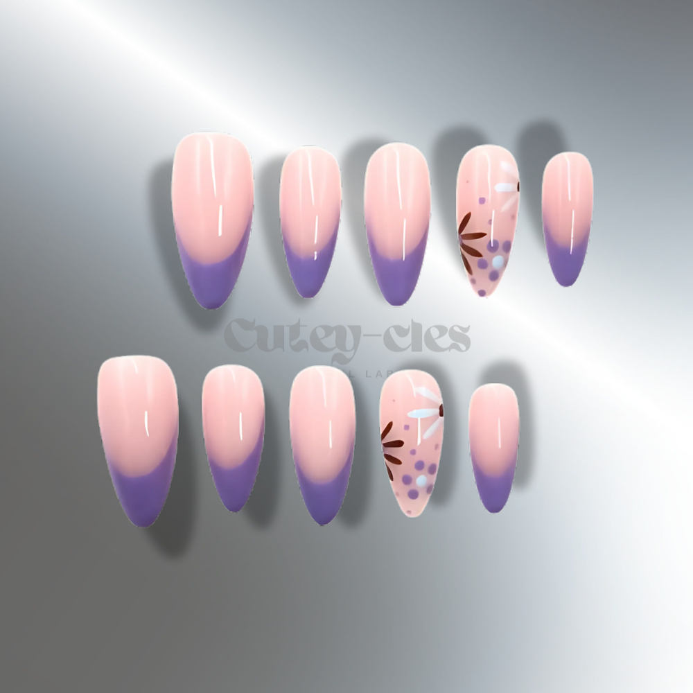 Medium-length almond-shaped press-on nails with pastel purple French tips and hand-painted floral accents on a blush pink base.