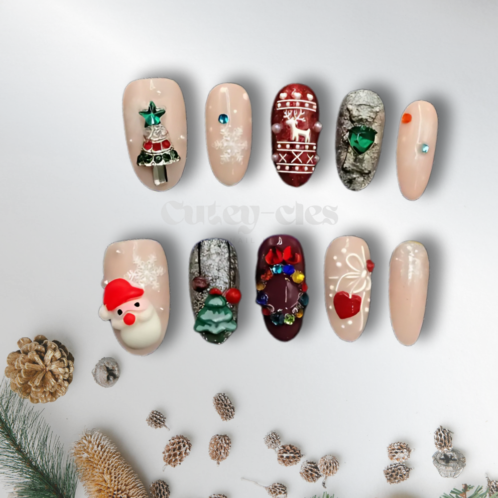 Christmas-themed press-on nails featuring 3D designs of Santa, reindeer, Christmas tree, wreath, snowflakes, and festive accents on a nude base.