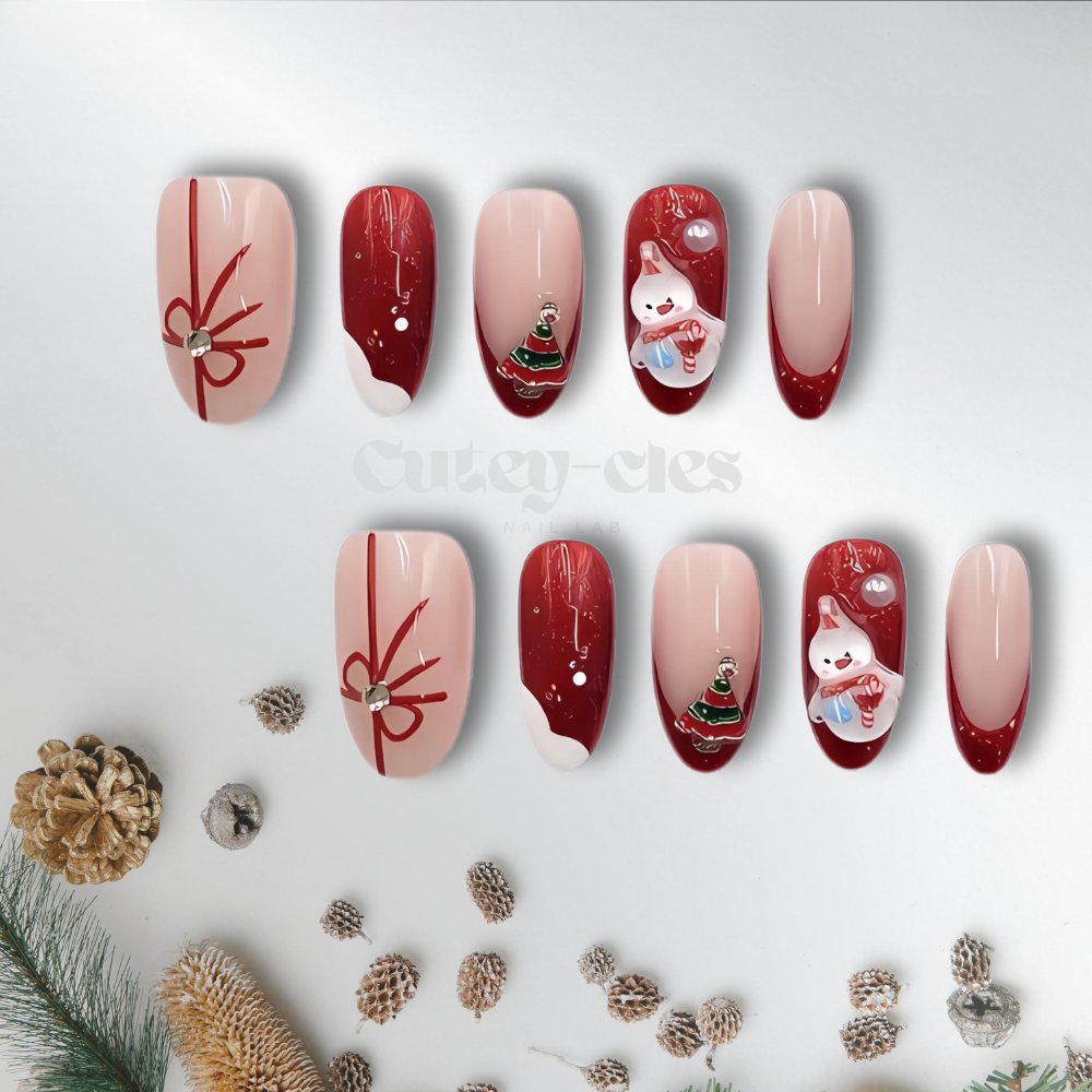 Holiday-themed oval-shaped press-on nails with red and white color palette, snowman accents, gift bows, and glossy finish.