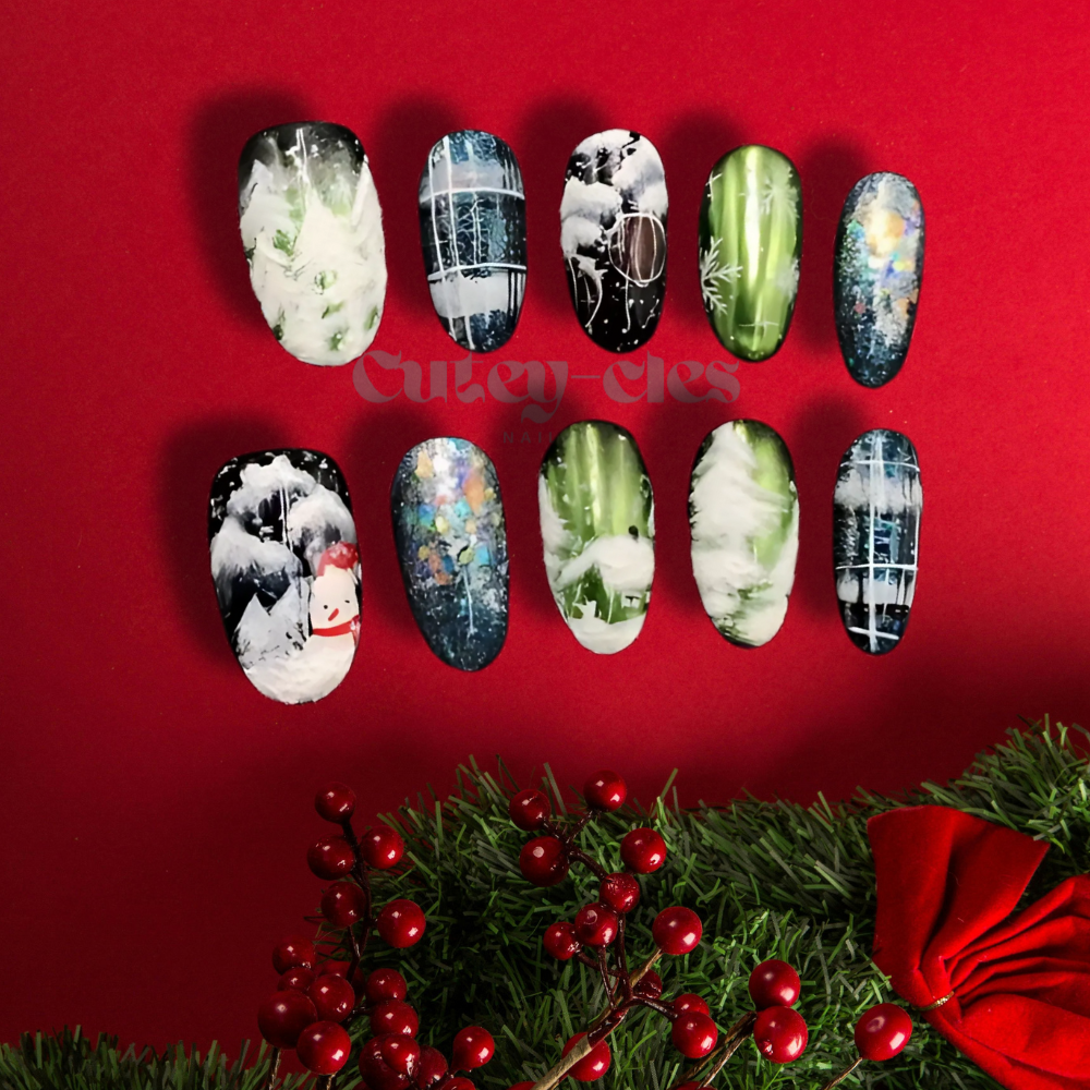 Hand-painted winter-themed press-on nails with snowflake and frosted tree, inspired by snow and winter landscapes.