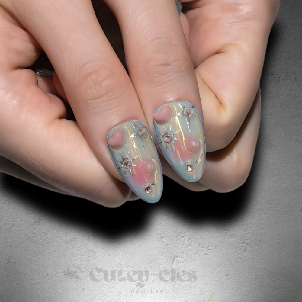 Medium almond press-on nail set showcasing pastel gradient designs, 3D bows, and pearls for a whimsical look.