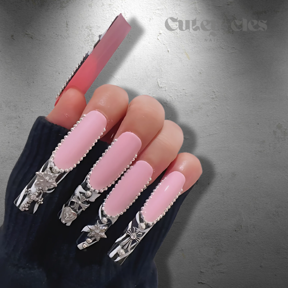 Pink and black 3xl black French tip press-on nails, silver charms, and intricate accents for a bold and stylish look.