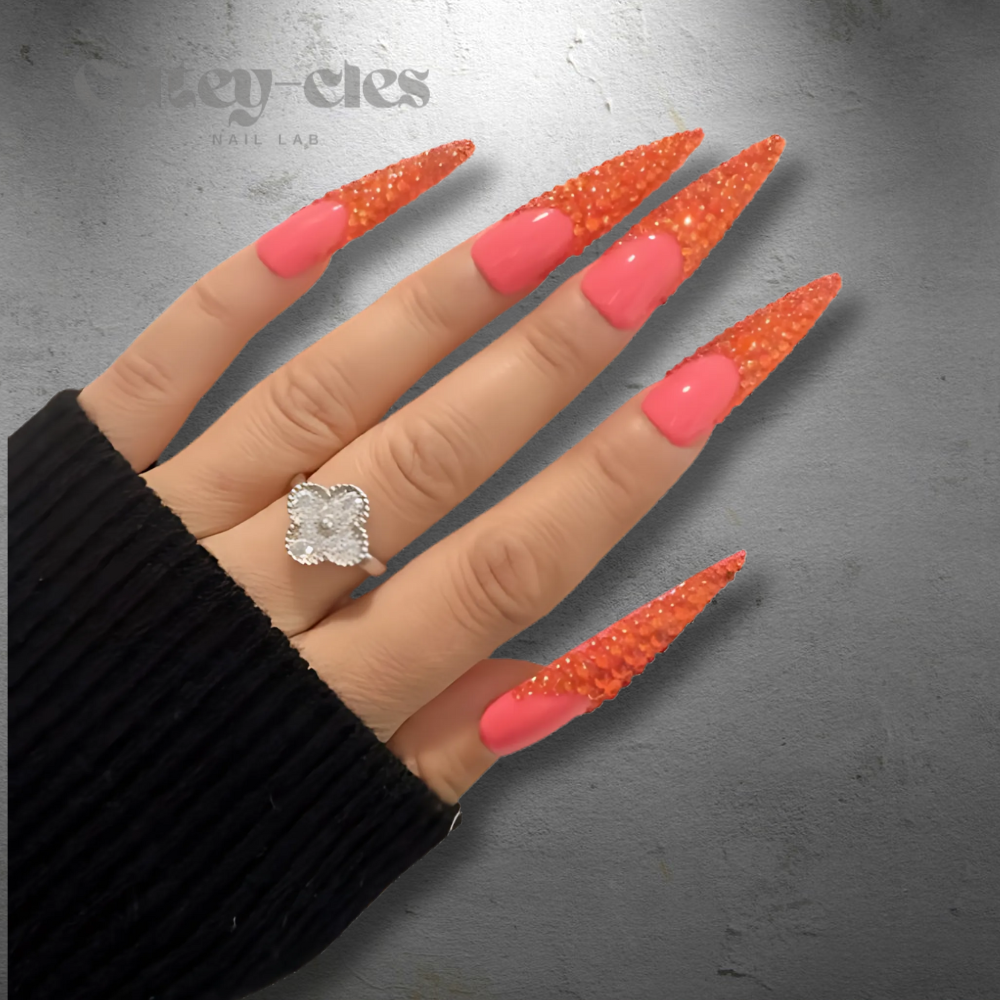 Vibrant 3D red stiletto nails with crystal embellishments, showcasing a bold and luxurious design.