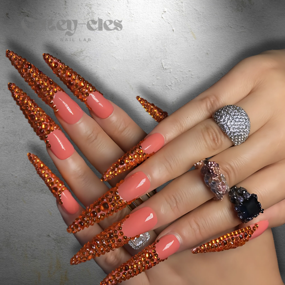 Vibrant 3D red stiletto nails with crystal embellishments, showcasing a bold and luxurious design.