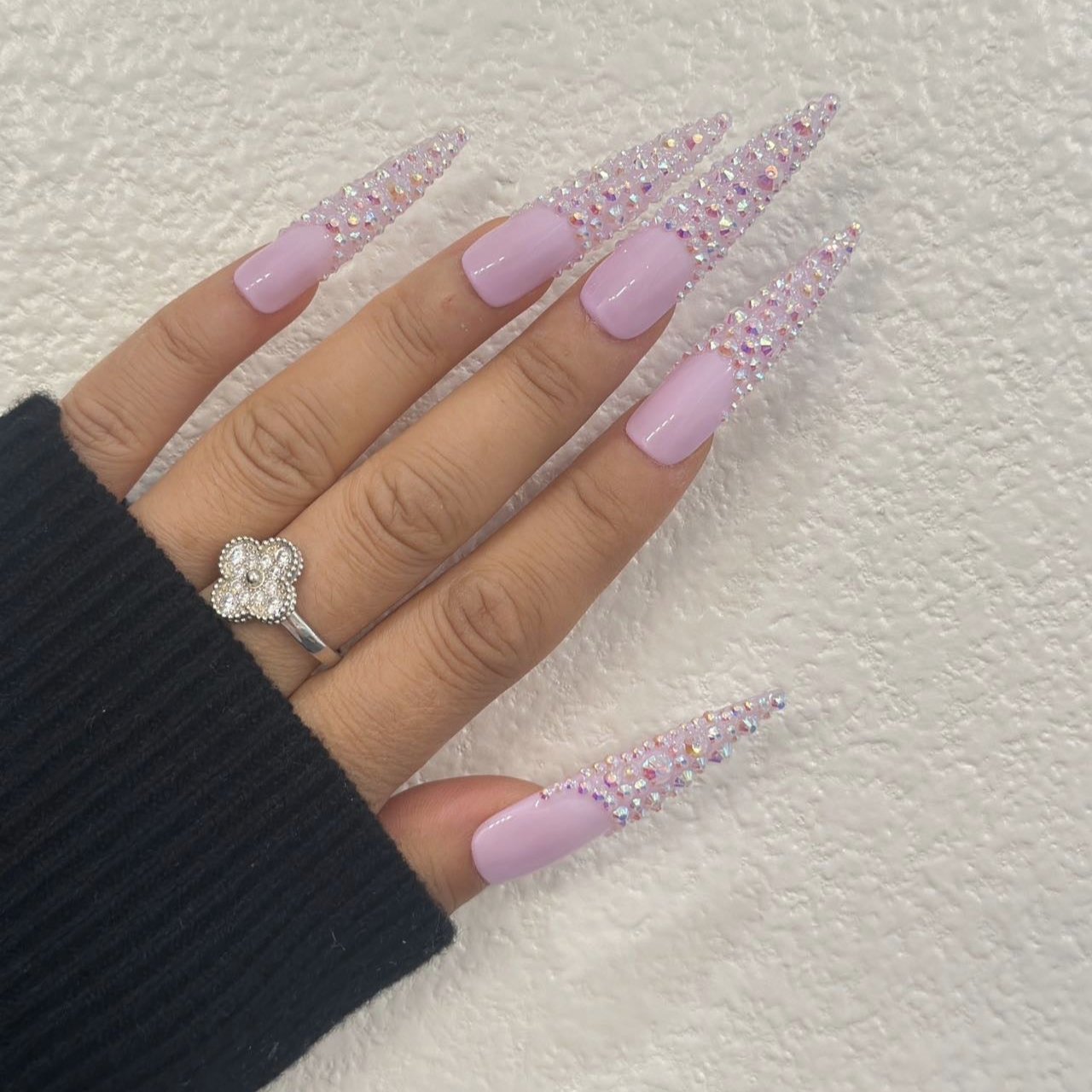 iridescent pink stiletto press-on nails adorned with sparkling crystals for a glamorous and elegant look.