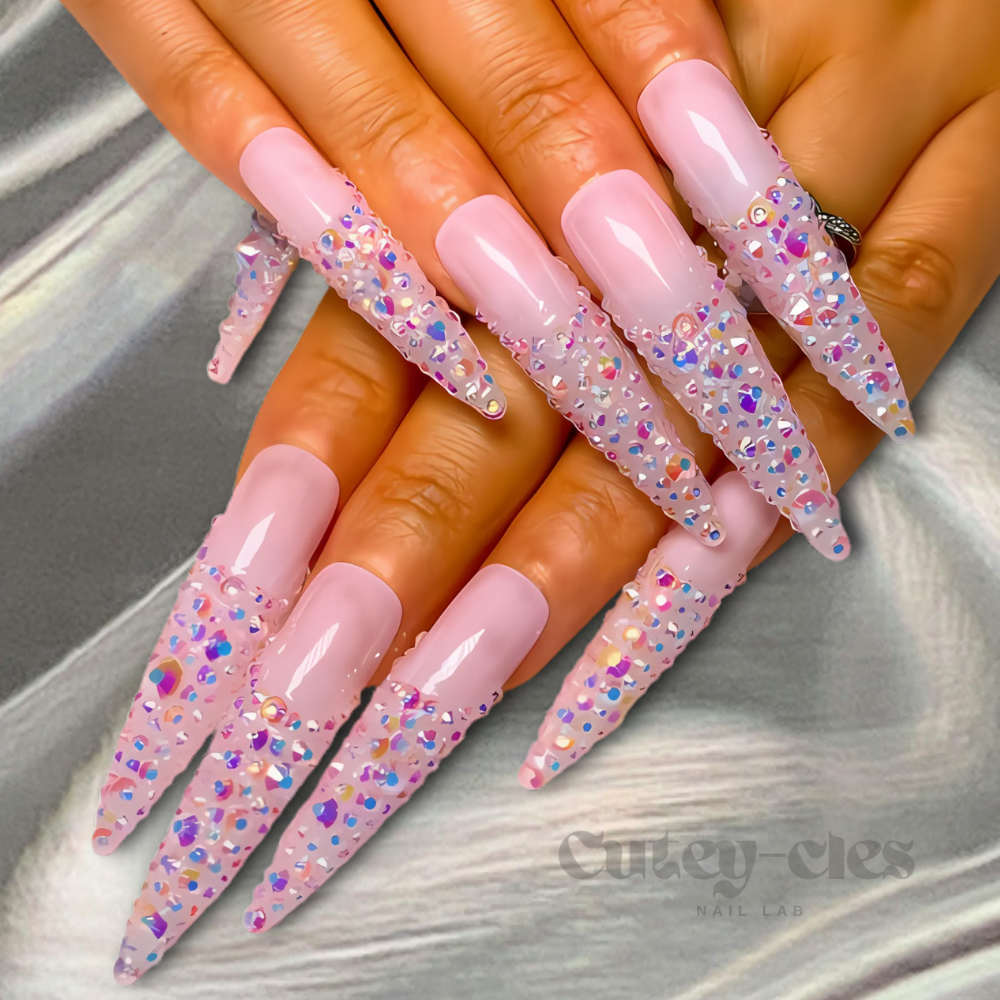 iridescent pink stiletto press-on nails adorned with sparkling crystals for a glamorous and elegant look.