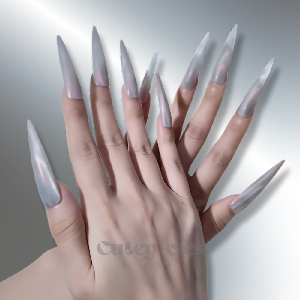 XL stiletto press-on nails with a pearlescent shimmer, showcasing a sleek and elongated design, worn with elegant silver and opal jewelry.