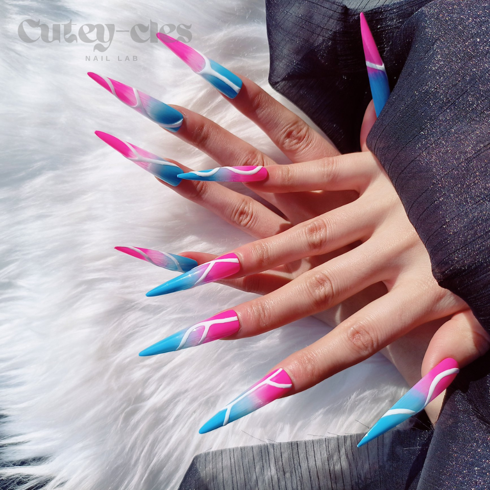 3XL stiletto press-on nails with a vibrant neon pink and blue base, featuring bold abstract white line art and a dramatic glossy finish.