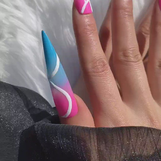 3XL stiletto press-on nails with a vibrant neon pink and blue base, featuring bold abstract white line art and a dramatic glossy finish.